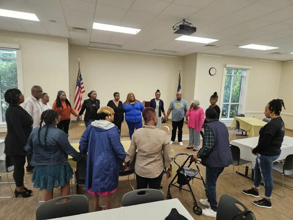 people holding hands in a circle